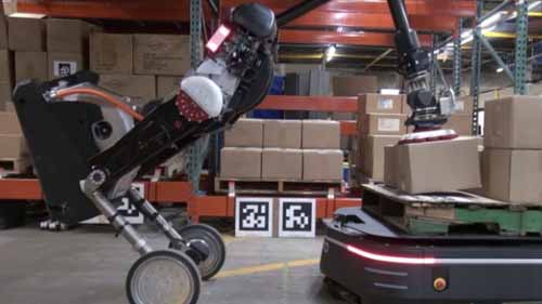 A robot loading packages in a warehouse